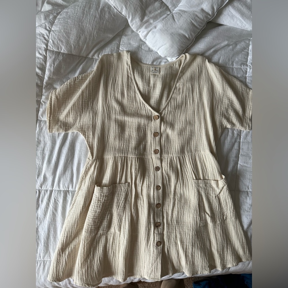 It’s cotton pocketed button down babydoll dress